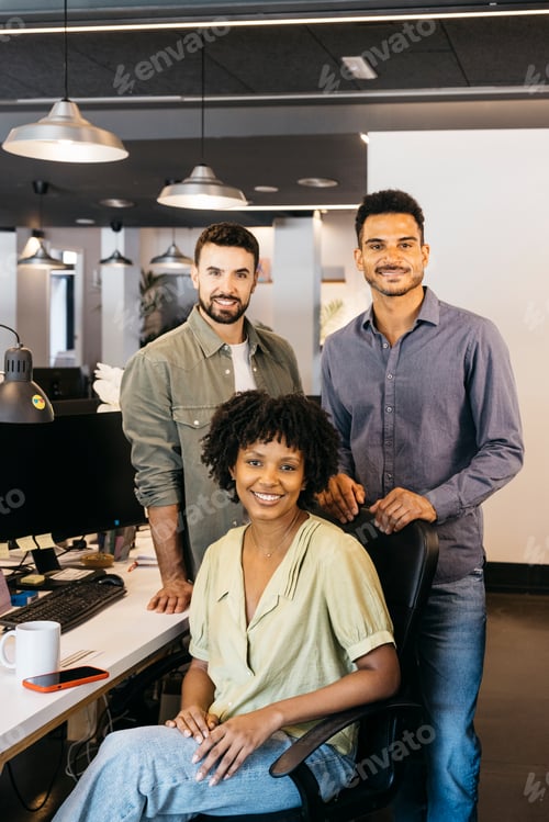 Preview: Diverse startup team smiling, collaborating in modern office