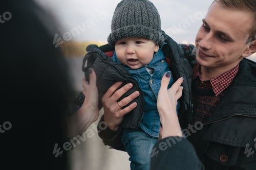Preview: young family and son walk along the lake shore