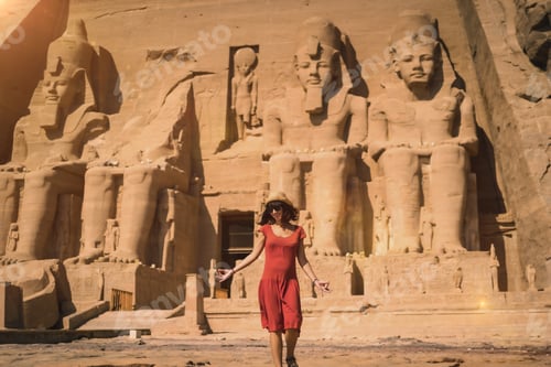Preview: A young tourist in a red dress entering the Abu Simbel Temple in southern Egypt