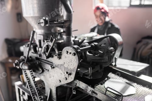 Preview: A young man is working baking blue corn tortillas with a nixtamall mill