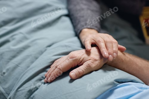 Preview: Senior Woman Placing Hand on Senior Man Hand Offering Support
