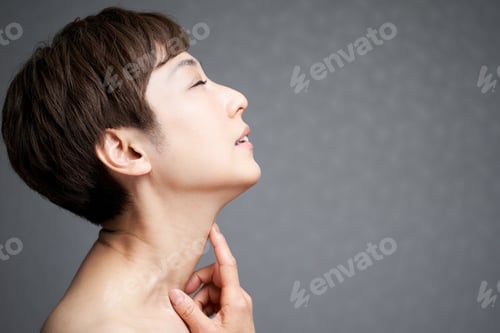 Preview: Middle-aged Japanese woman holding her neck
