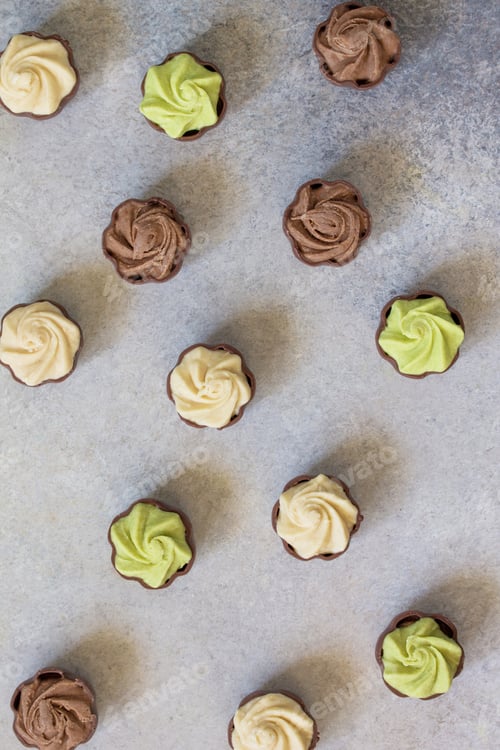 Preview: Chocolate with vanilla, chocolate and pistachio cream on marble background.