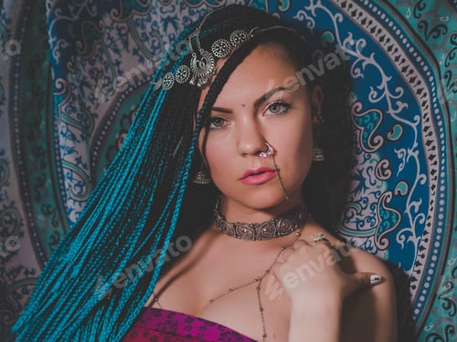 Preview: Portrait of young beautiful woman with blue kanekalon braided hairstyle in Indian jewelry and saree