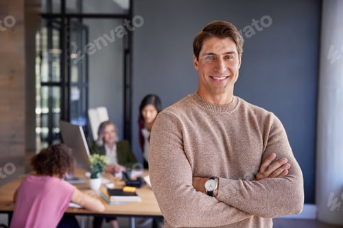 Preview: Confident team leader looking at camera on creative office