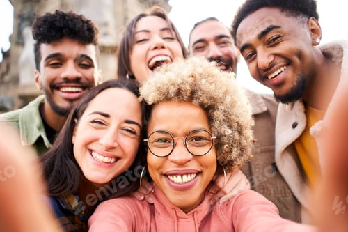Preview: Young multiracial people taking a selfie with smartphone and having fun in the city