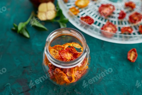 Preview: Homemade sun dried tomatoes with herbs, garlic in olive oil in a glass jar