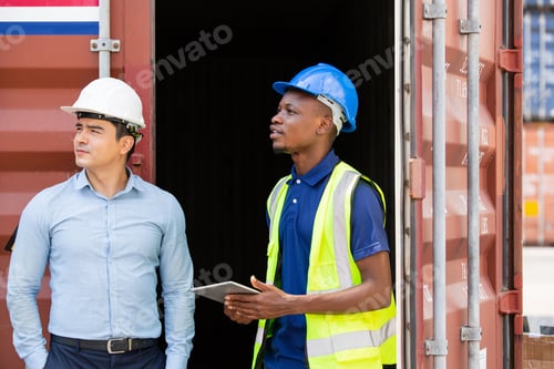 Preview: Logistic foreman discussing business work with African contractor worker at container warehouse