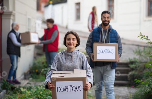 Preview: Preteen girl volunteer with team delivering donation boxes and looking at camera, social care