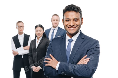 Preview: smiling african american businessman in formal wear with colleagues behind, isolated on white