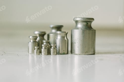 Preview: Set of pharmacy laboratory precision weights for a balance scale on an old table. Pharmacy set of