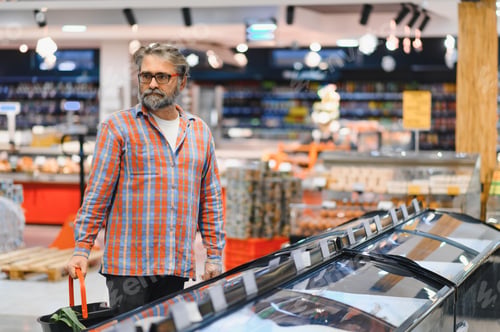 Preview: Senior man at grocery store products