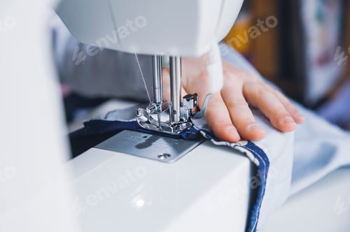Preview: young girl working with sewing machine