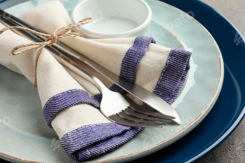 Preview: Stylish setting with cutlery, plates, bowl and napkin on grey table, closeup
