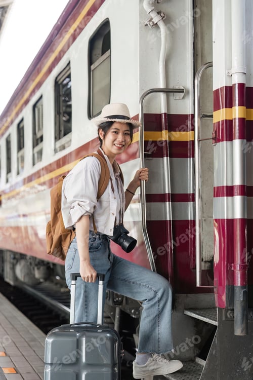 Preview: Woman traveler tourist walking with luggage at train station. travel lifestyle concept