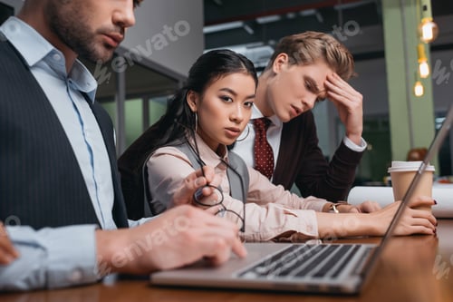 Preview: businessmen and asian businesswoman working together with laptop in office