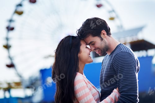 Preview: romantic couple embracing with santa monica pier in background