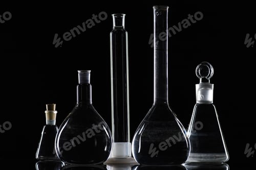 Preview: transparent glass flasks with substance in laboratory on black