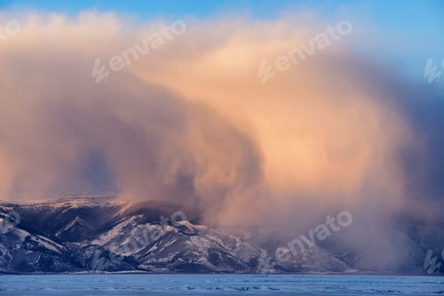 Preview: Low storm clouds rolling over snow capped mountains, Baikal Lake, Olkhon Island, Siberia, Russia