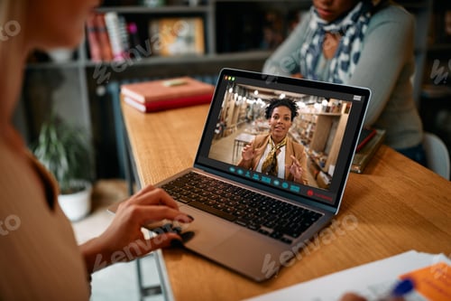 Preview: Close-up of black female professor having video call via laptop with her students.