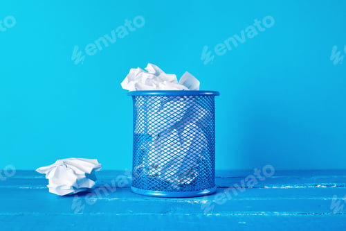 Preview: Blue metal bucket filled with crumpled white paper