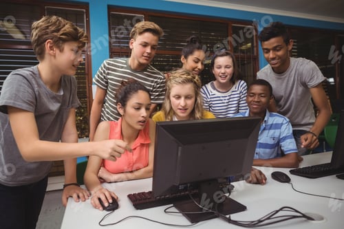 Preview: Smiling students studying together in computer classroom