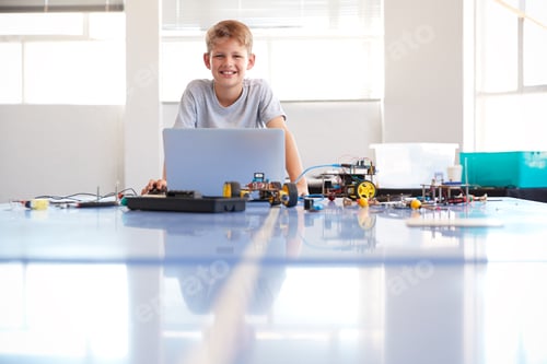 Preview: Portrait Of Male Student Building And Programing Robot Vehicle In School Computer Coding Class