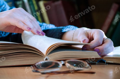 Preview: girl reading a book, flipping a page