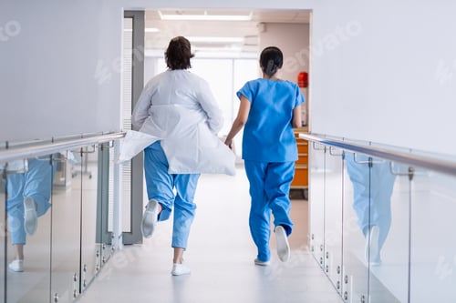 Preview: Nurse and doctor running in hospital corridor