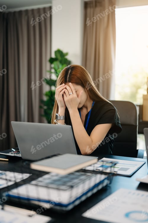 Preview: Asian business woman is stressed, bored, and overthinking from working on a tablet