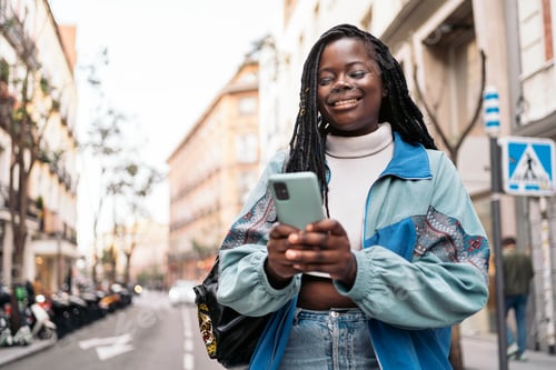 Preview: Happy African Girl Using Phone