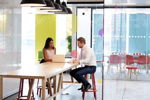 Preview: Man and woman having an informal meeting at work