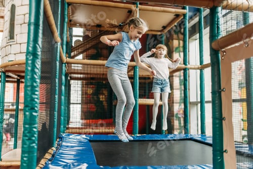 Preview: Girls jumping on trampoline, children game center