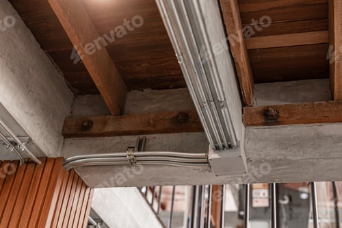 Preview: Conduit metal power pipe, Electrical power line system pipeline connector installed at wood ceiling.
