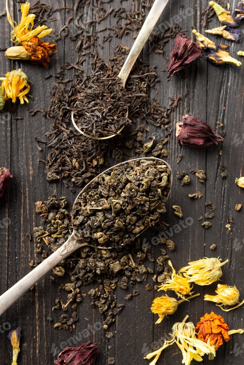 Preview: Dry green and black tea, flower tea on a dark background top view close-up.