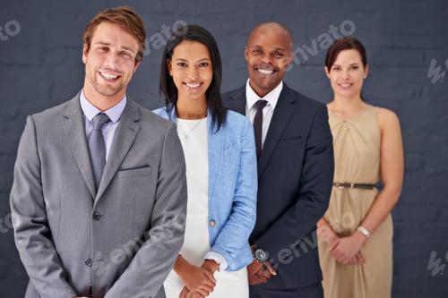 Preview: Portrait of a group of confident businesspeople standing against a gray background