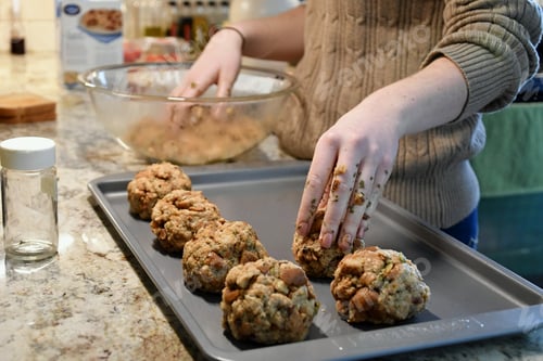 Preview: Forming stuffing or dressing balls for the holidays and placing them on a baking tray