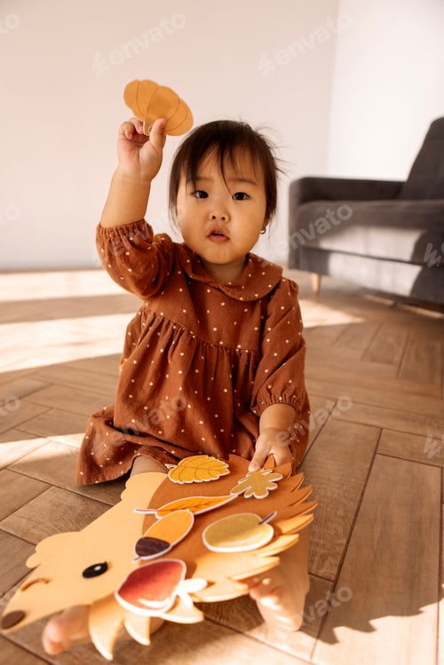 Preview: A cute little Asian girl is playing on the living room floor