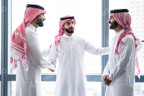 Preview: Arab businessmen wearing saudi kandura meeting in office for business deal