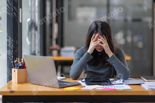 Preview: Portrait of tired young business Asian woman work with documents tax laptop computer in office. Sad,