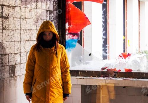 Preview: Young woman in yellow hoodie jacket in abandoned room