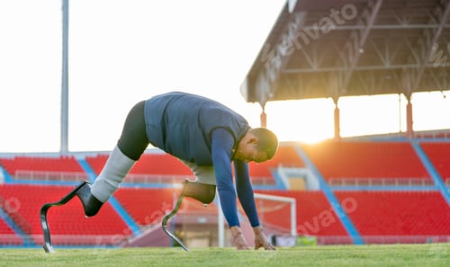 Preview: Sport man athlete prosthesis legs stay in the position of run exercise at the stadium soft light