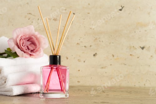 Preview: Relaxing atmosphere created by a pink diffuser and a rose on a soft towel