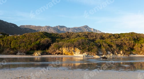 Preview: Woodland and mountains scenery, a small sheltered sandy beach on the Atlantic shore.