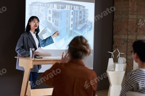 Preview: Woman talking about architectural blueprint