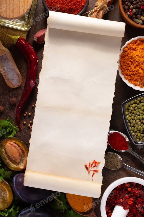 Preview: Variety of spices and herbs with cookbook paper at table background