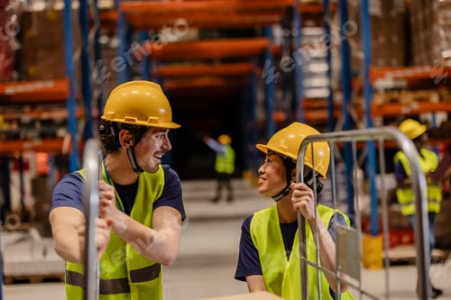 Preview: Warehouse workers moving inventory using hand pallet truck and talking