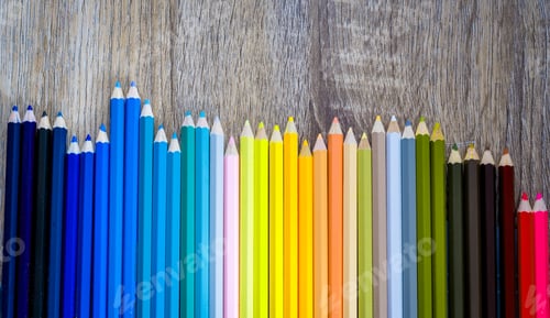Preview: Multi Color pencils in scale with rainbow style isolated on wooden background