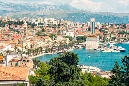 Preview: Aerial view of a Split city with historic architecture, modern buildings, and moored boats