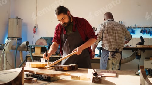 Preview: Woodworking expert in studio doing putting coats of oil on wood plank
